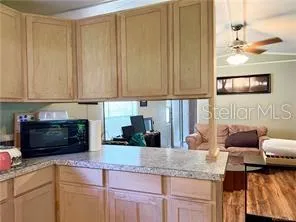 a kitchen with granite countertop a sink and a stove top oven