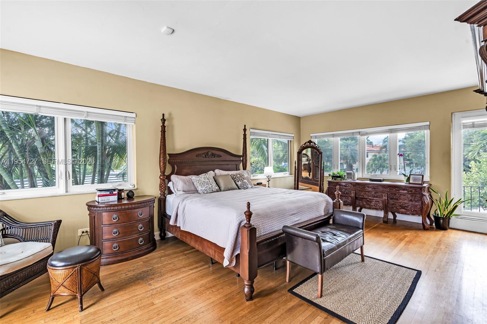 5965 Alton Road Miami Beach, FL 33140 - Photo 21 of 29 a bedroom with a bed and wooden floor