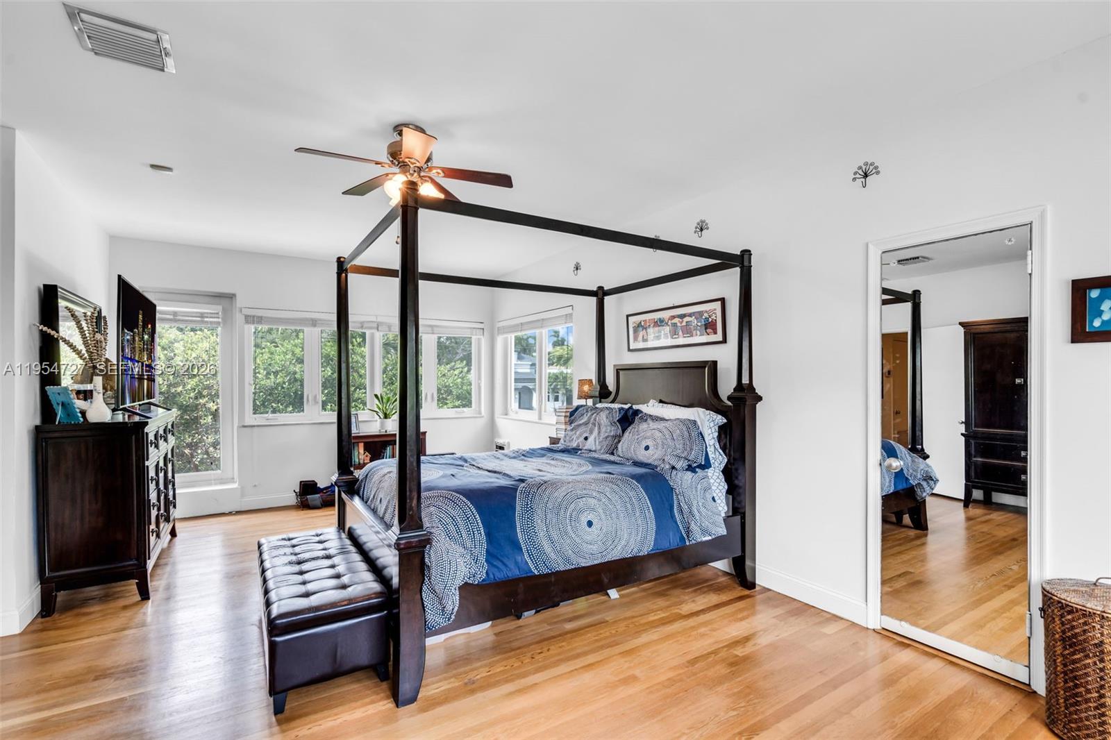 5965 Alton Road Miami Beach, FL 33140 - Photo 24 of 29 a bedroom with furniture and a flat screen tv