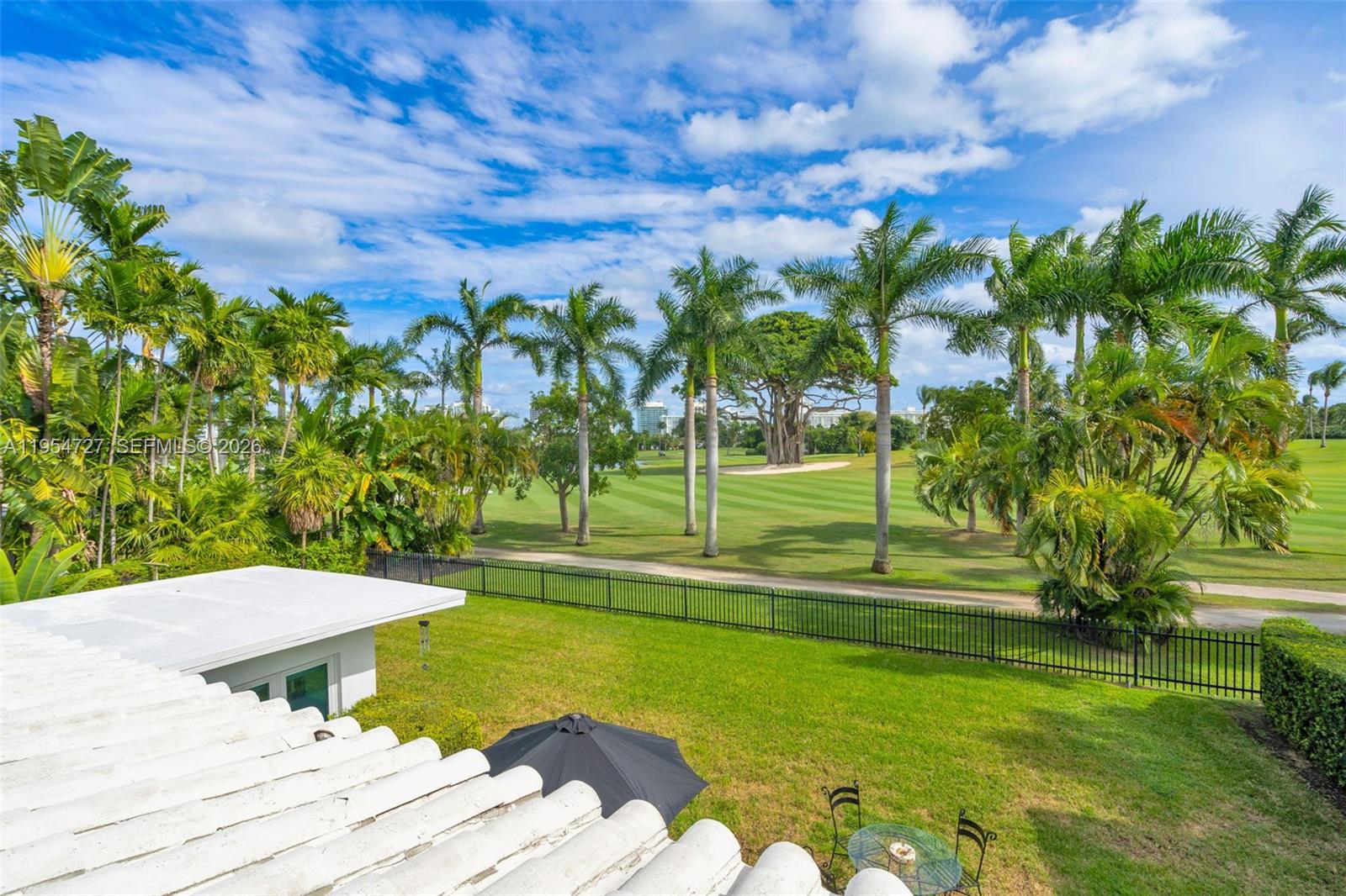 5965 Alton Road Miami Beach, FL 33140 - Photo 27 of 29 a view of a swimming pool with a yard