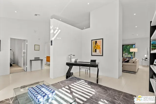 a bedroom with furniture and a wooden floor