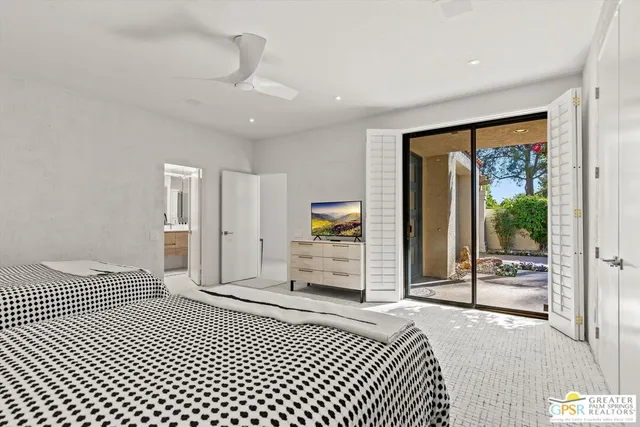 a bedroom with a balcony a bed and a walk in closet