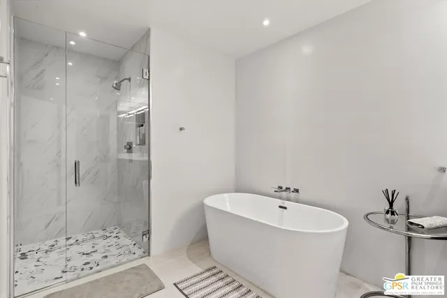 a bathroom with a bathtub and shower