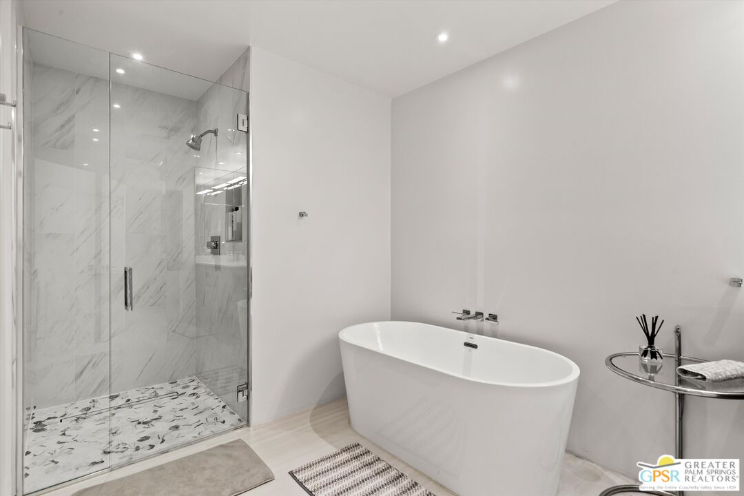 10201 Lakeview Drive Rancho Mirage, CA 92270 - Photo 19 of 28 a bathroom with a bathtub and shower