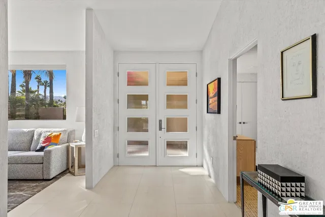 a living room with furniture and a book shelf