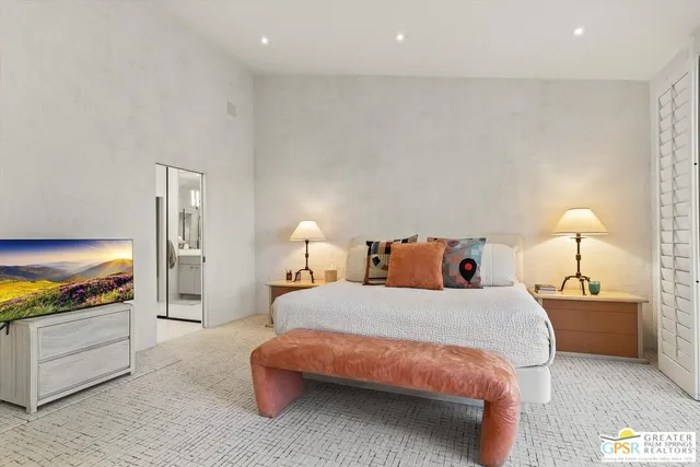 a bedroom with a bed and a lamp