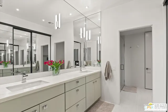 a bathroom with a double vanity sink mirror and double