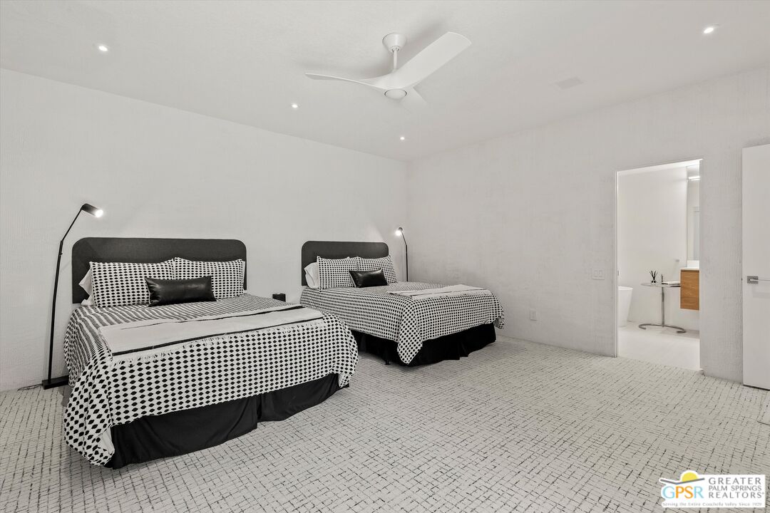 10201 Lakeview Drive Rancho Mirage, CA 92270 - Photo 7 of 28 a bedroom with two beds and a walk in closet