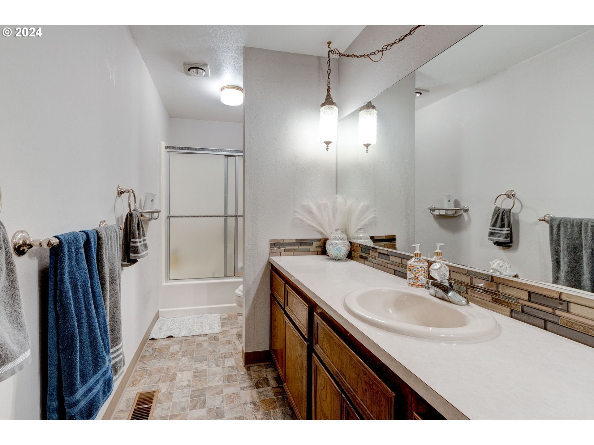24100 Southwest Rosa Road Hillsboro, OR 97123 - Photo 19 of 30 a bathroom with a sink a toilet a tub and a mirror