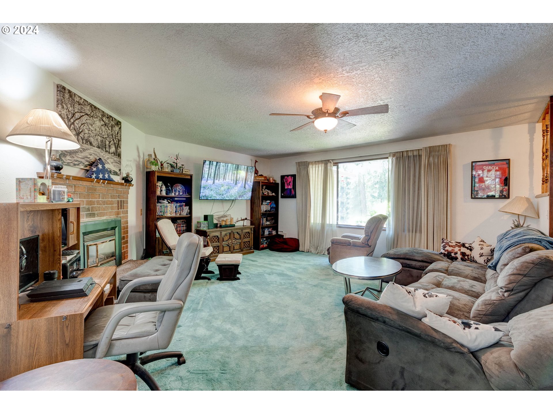 24100 Southwest Rosa Road Hillsboro, OR 97123 - Photo 5 of 30 a living room with furniture a chandelier and a window