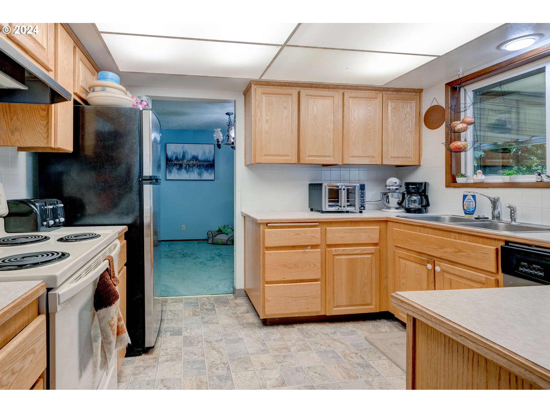 24100 Southwest Rosa Road Hillsboro, OR 97123 - Photo 9 of 30 a kitchen with a stove a sink and a refrigerator