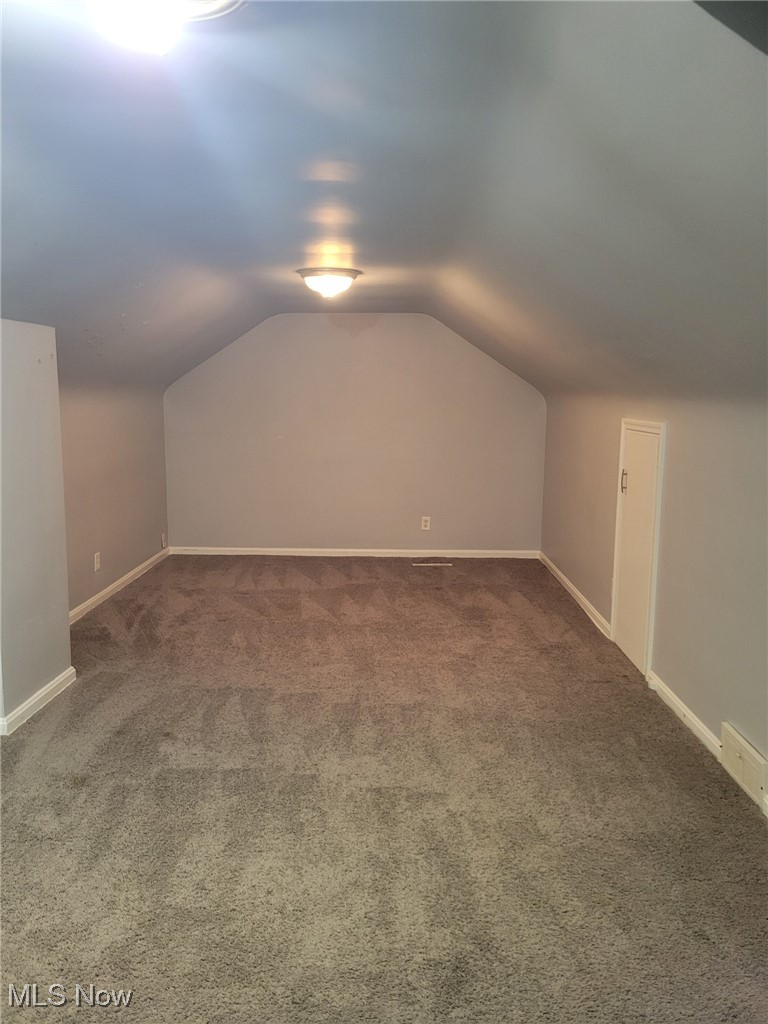 2440 Midvale Road Northwest Canton, OH 44708 - Photo 12 of 22 Bonus room with carpet and vaulted ceiling