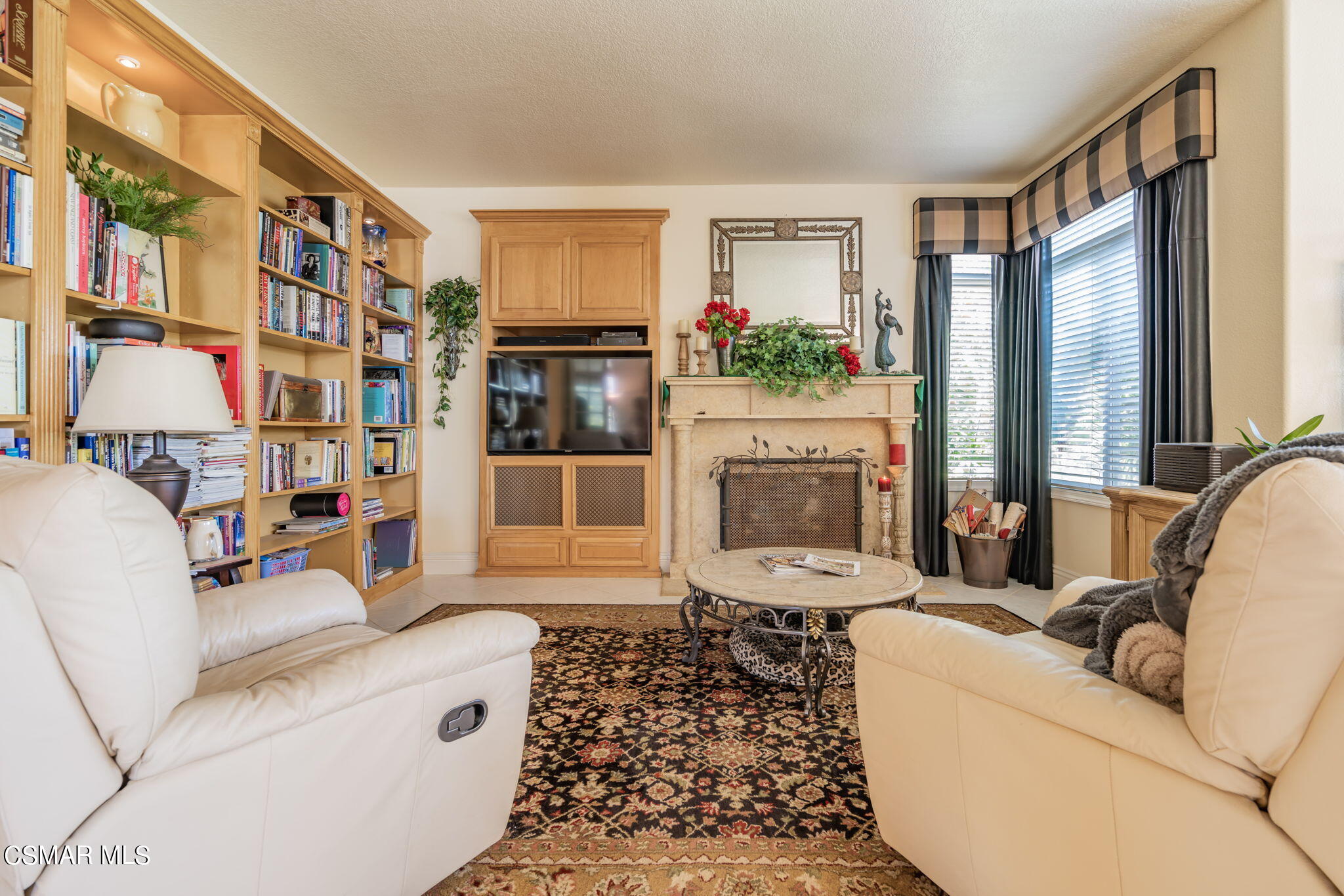 15606 Harte Lane Moorpark, CA 93021 - Photo 17 of 75 a living room with furniture a fireplace and a large window