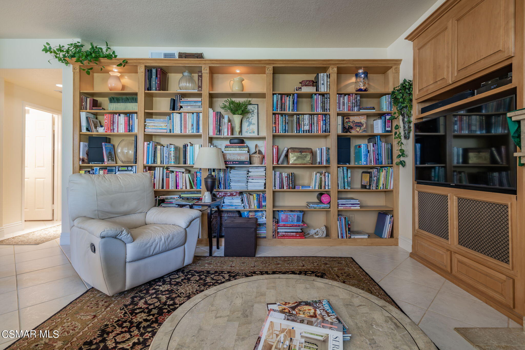 15606 Harte Lane Moorpark, CA 93021 - Photo 19 of 75 a living room with furniture and a book shelf