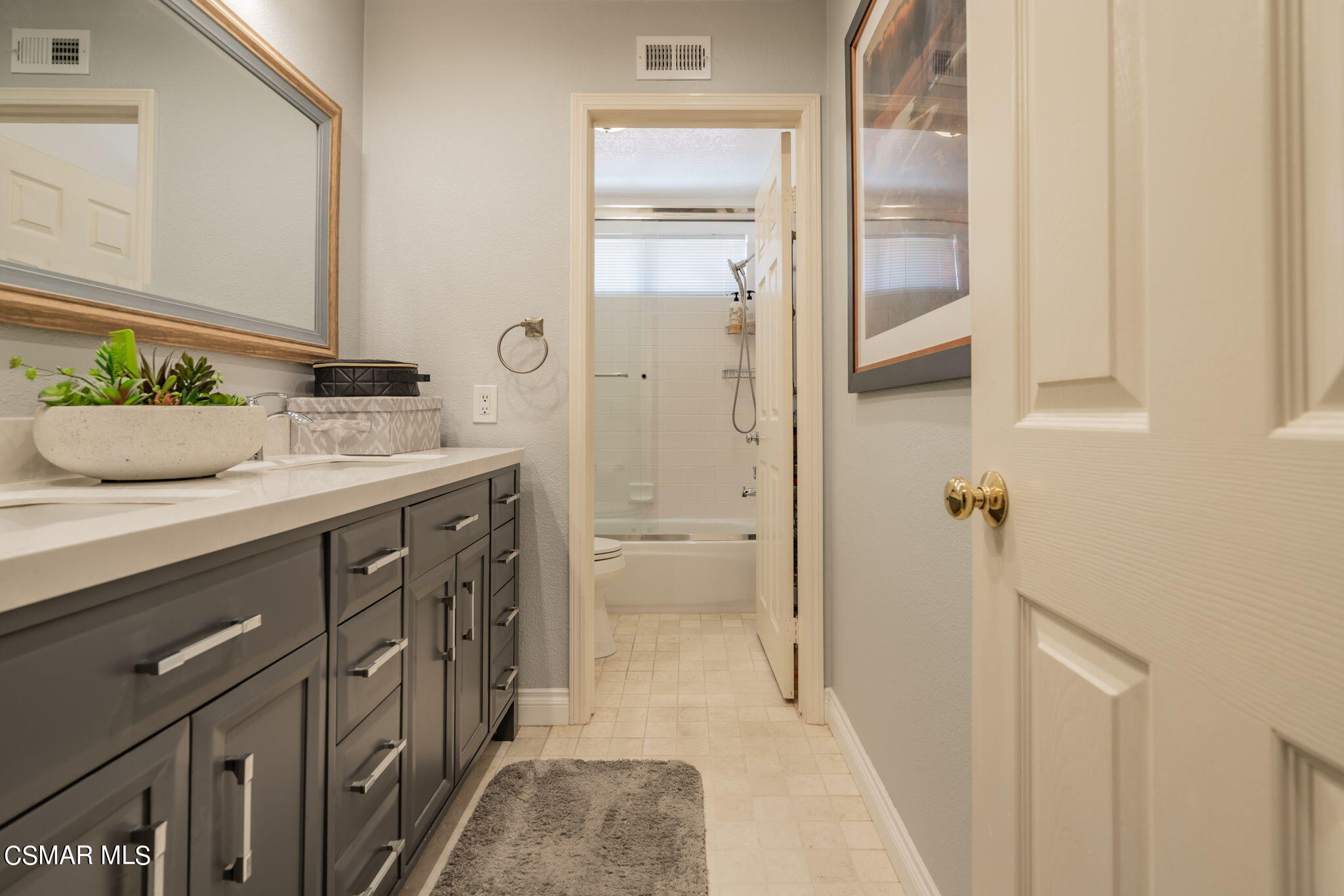 15606 Harte Lane Moorpark, CA 93021 - Photo 39 of 75 a bathroom with a granite countertop sink a mirror and a shower