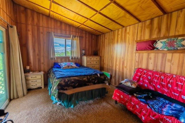 1840 East Ridge Road, Unit 177 Salina, UT 84654 - Photo 8 of 26 Wood-paneled room featuring a vaulted ceiling with exposed beams, a window overlooking a natural landscape, and a glass sliding door