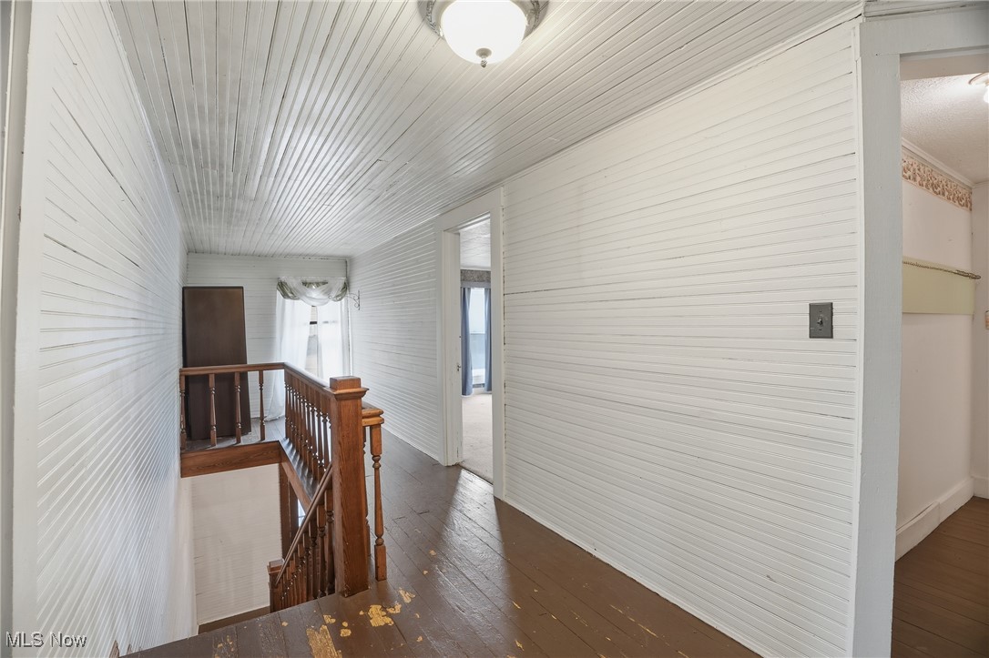 8045 Veto Road Belpre, OH 45714 - Photo 36 of 50 Hallway with an upstairs landing and dark wood-style floors