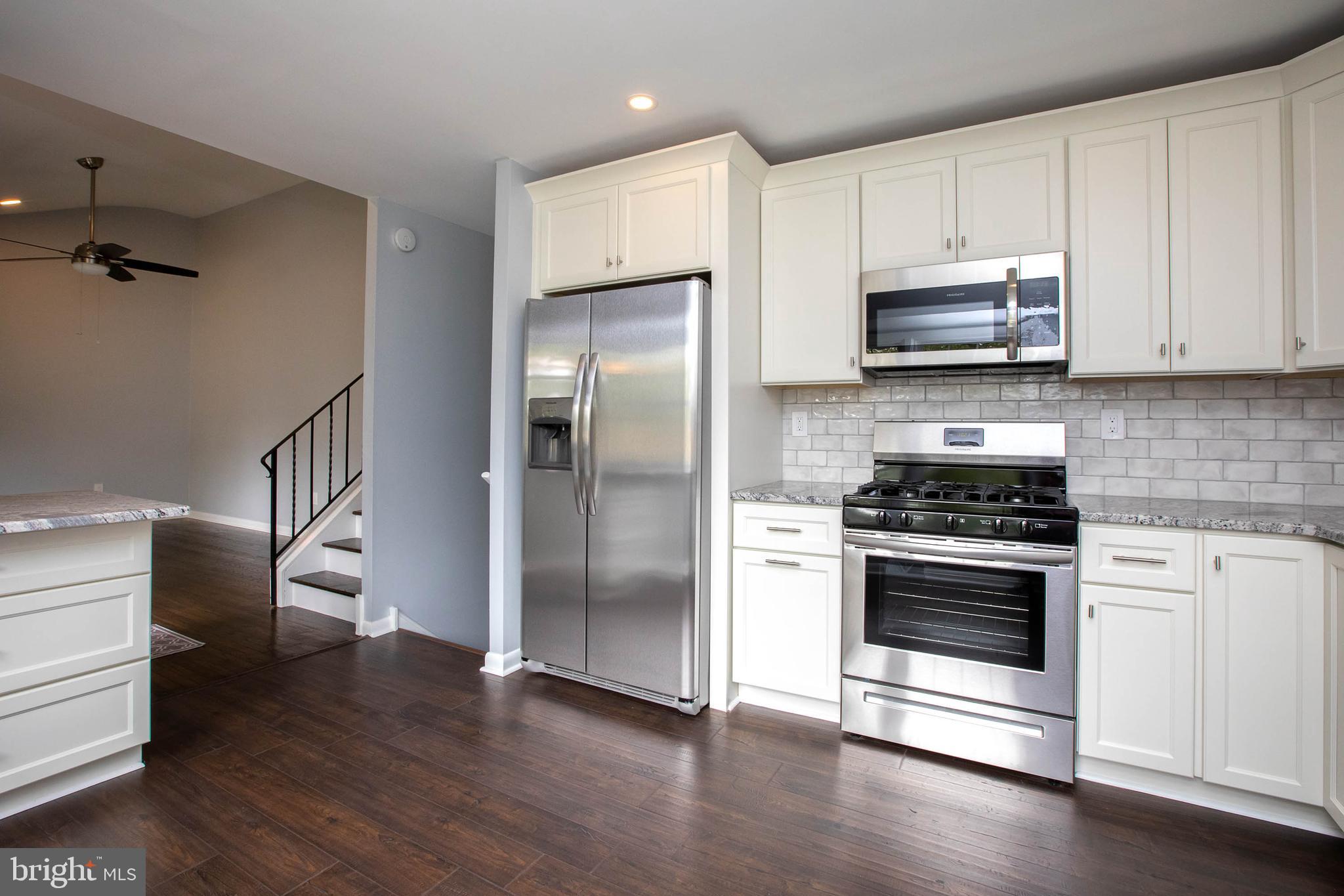 145 Forrest Avenue Runnemede, NJ 08078 - Photo 3 of 40 a kitchen with stainless steel appliances granite countertop a stove a refrigerator and a stove top oven