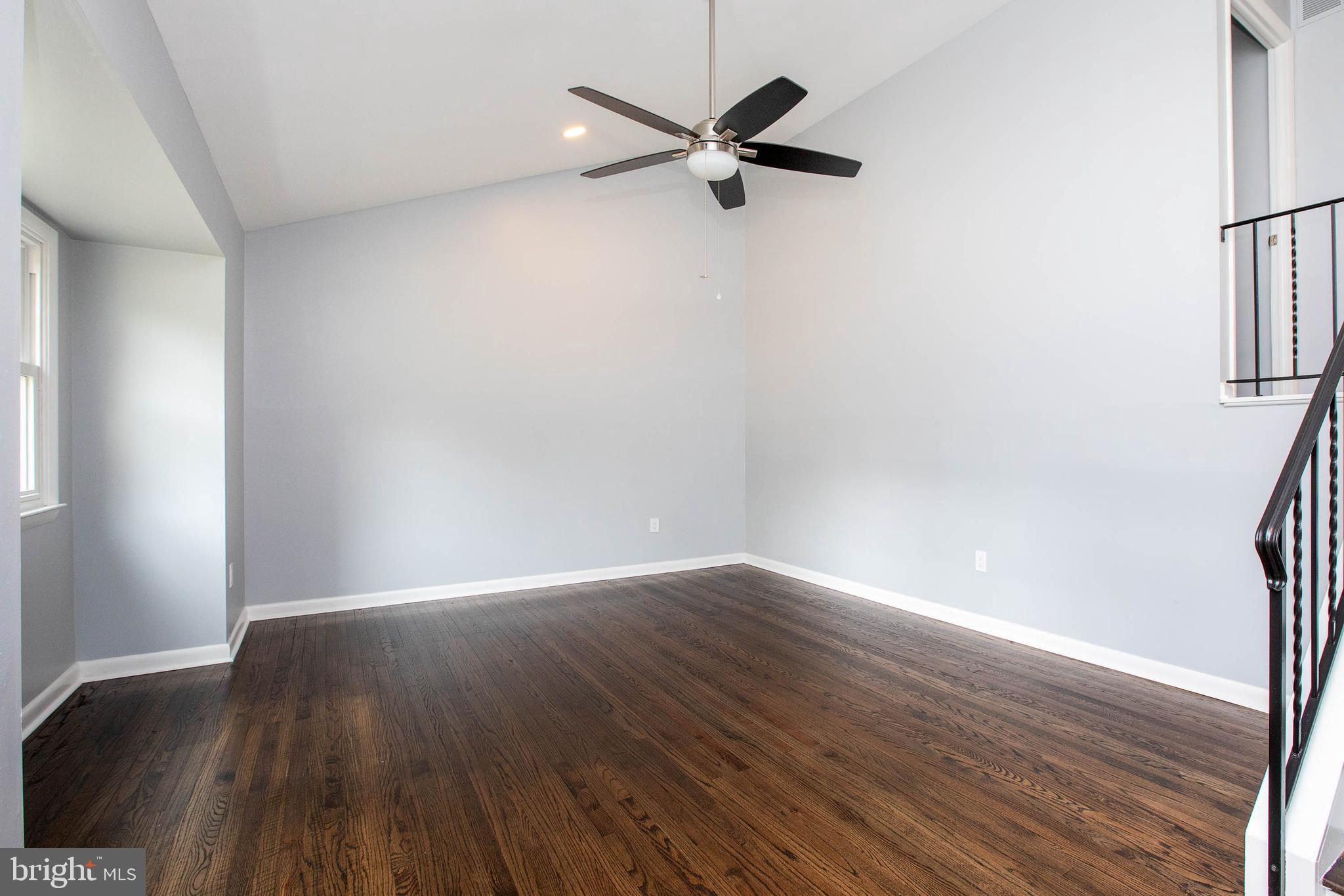 145 Forrest Avenue Runnemede, NJ 08078 - Photo 6 of 40 a view of a room with wooden floor and a ceiling fan