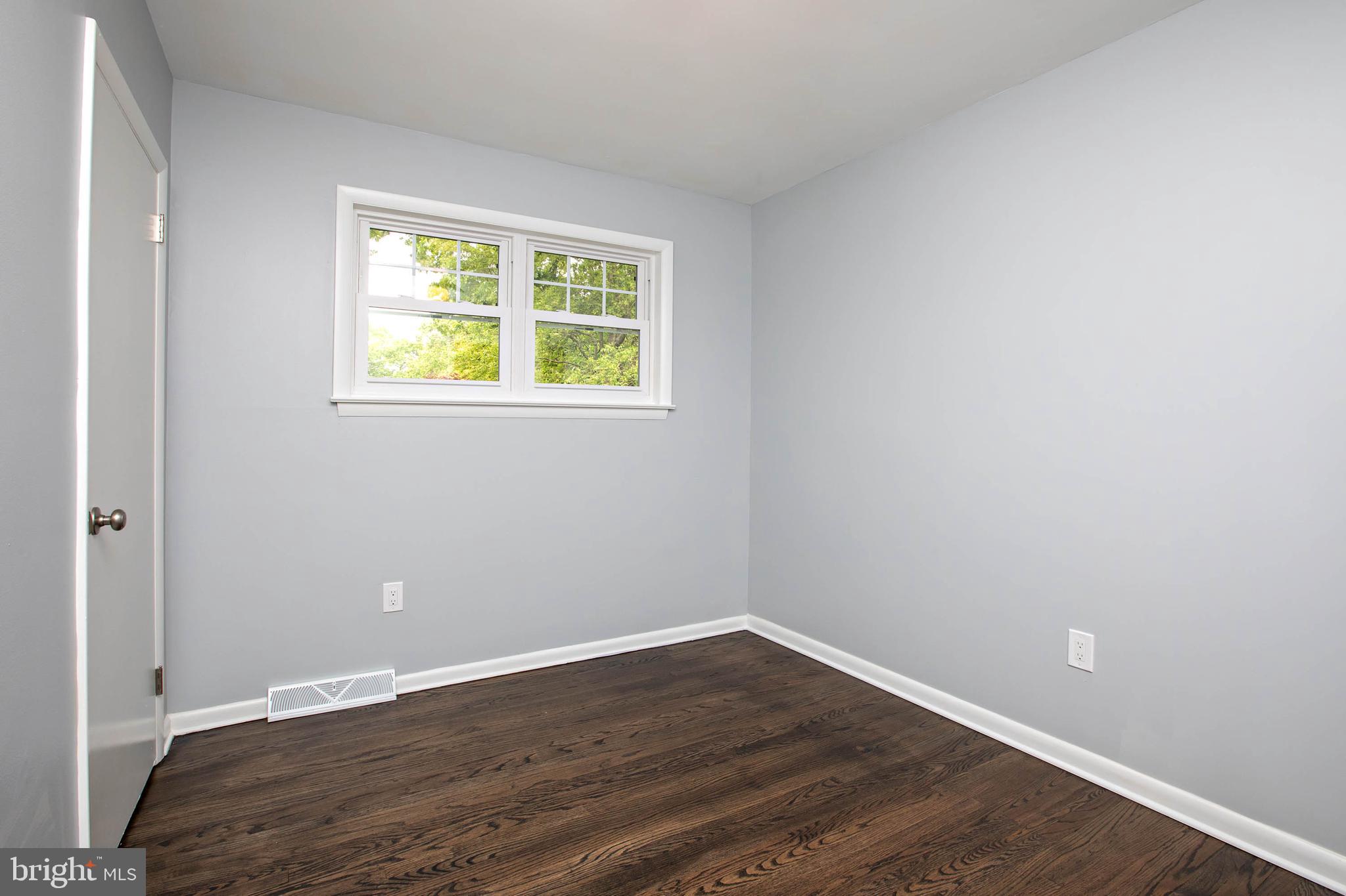 145 Forrest Avenue Runnemede, NJ 08078 - Photo 8 of 40 a view of an empty room with wooden floor and a window