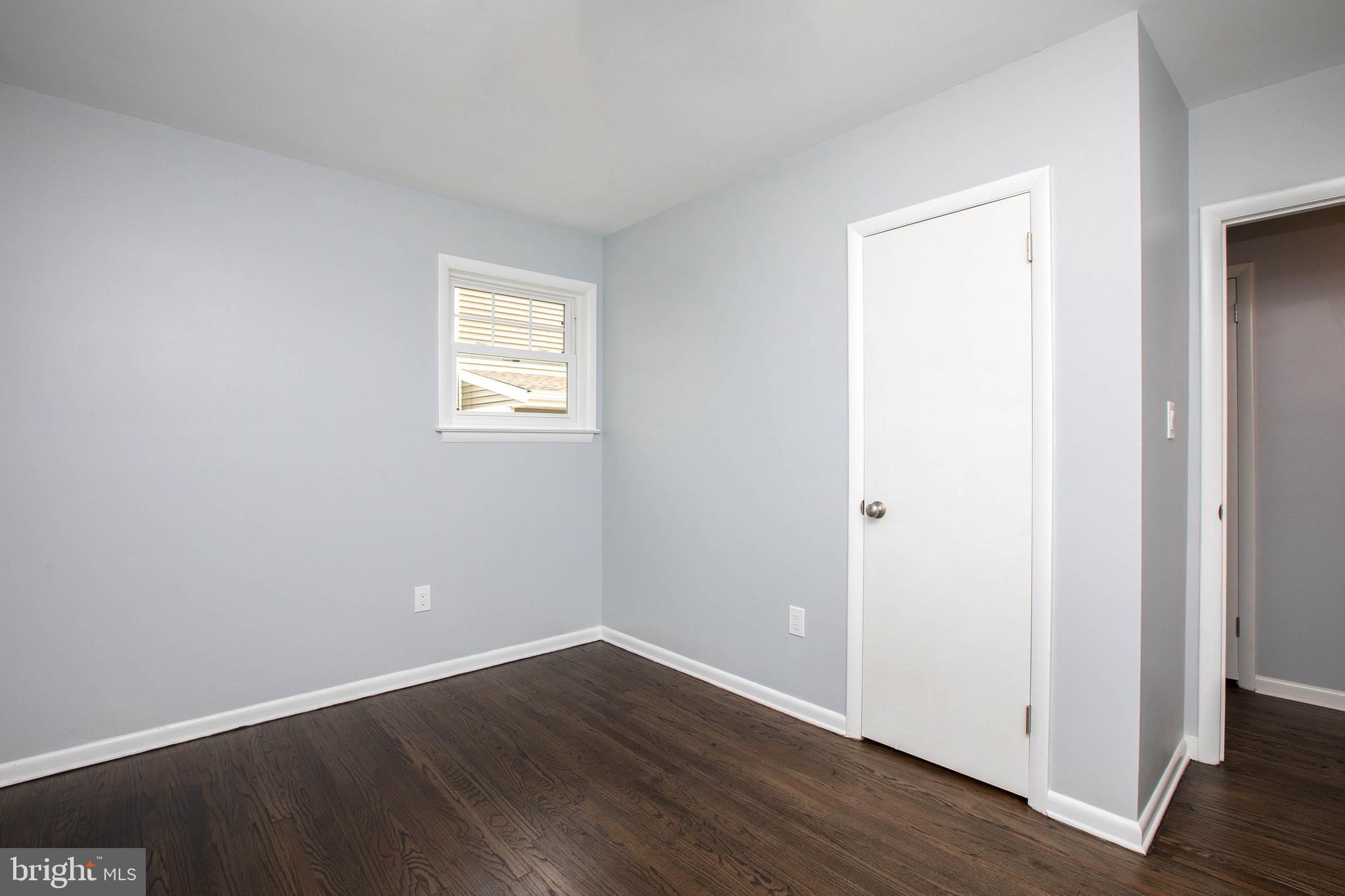 145 Forrest Avenue Runnemede, NJ 08078 - Photo 9 of 40 an empty room with wooden floor and windows