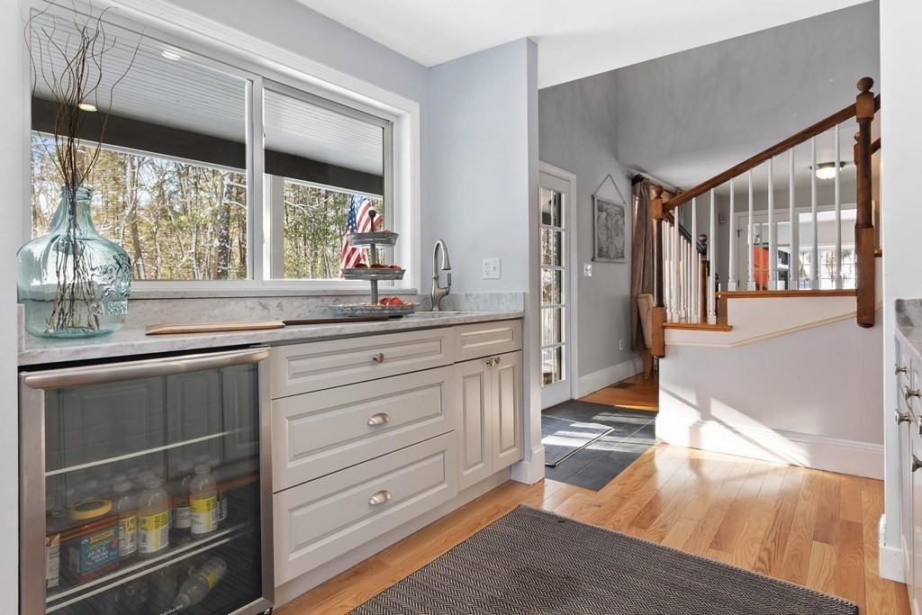 64 Jenkins Road Andover, MA 01810 - Photo 11 of 31 a kitchen with a window wooden floor and glass doors