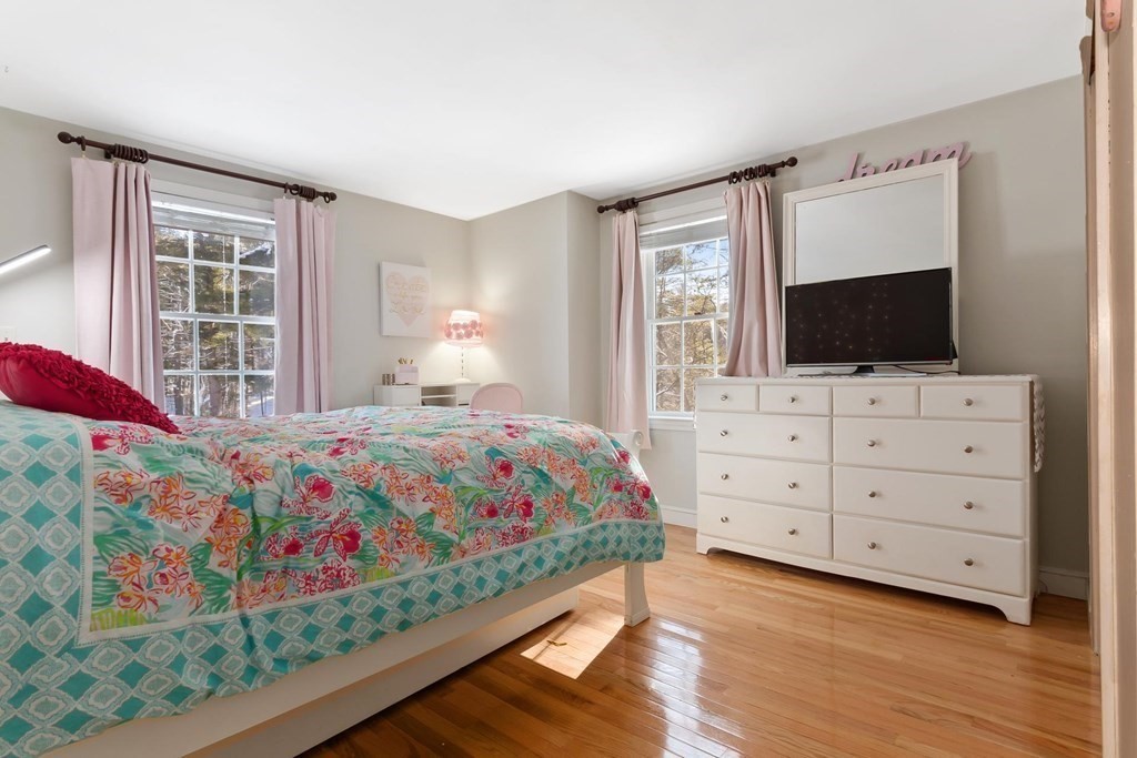 64 Jenkins Road Andover, MA 01810 - Photo 22 of 31 a bedroom with a bed and a flat screen tv in it