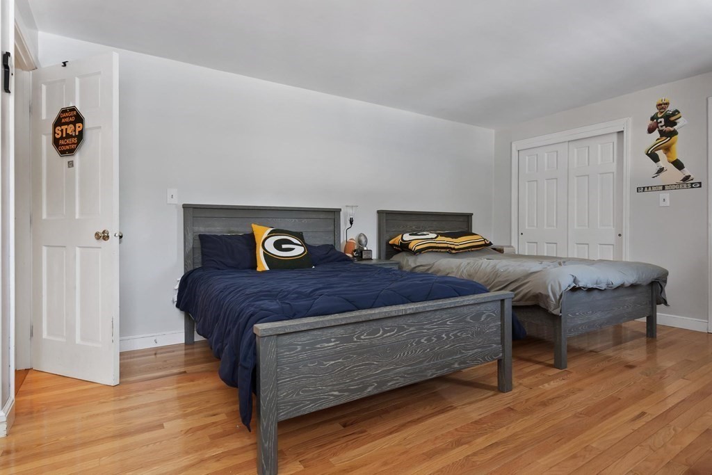 64 Jenkins Road Andover, MA 01810 - Photo 23 of 31 a bedroom with a bed and wooden floor