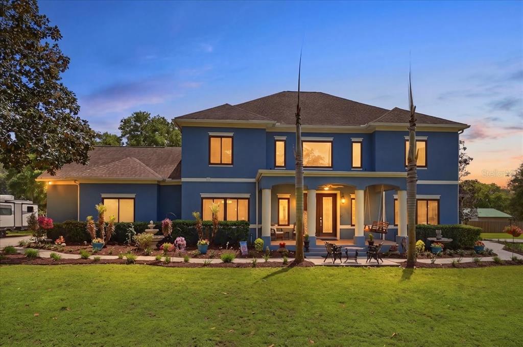 a front view of a house with swimming pool having outdoor seating