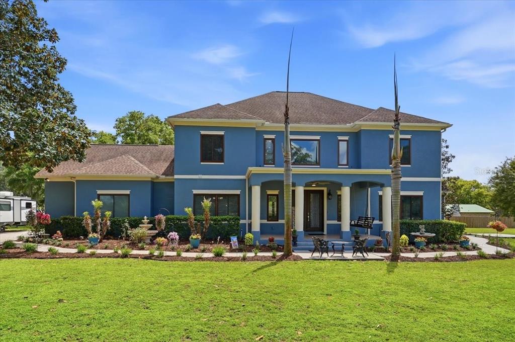3943 West Campbell Road Lakeland, FL 33810 - Photo 2 of 95 a front view of a house with swimming pool having outdoor seating