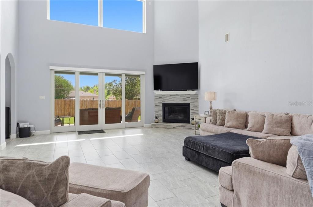 3943 West Campbell Road Lakeland, FL 33810 - Photo 26 of 95 a living room with furniture a flat screen tv and a fireplace