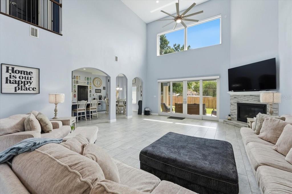 3943 West Campbell Road Lakeland, FL 33810 - Photo 28 of 95 a living room with furniture a fireplace and a flat screen tv