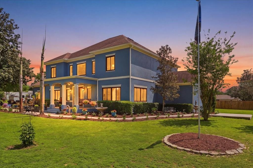 3943 West Campbell Road Lakeland, FL 33810 - Photo 3 of 95 a front view of a house with a yard table and chairs