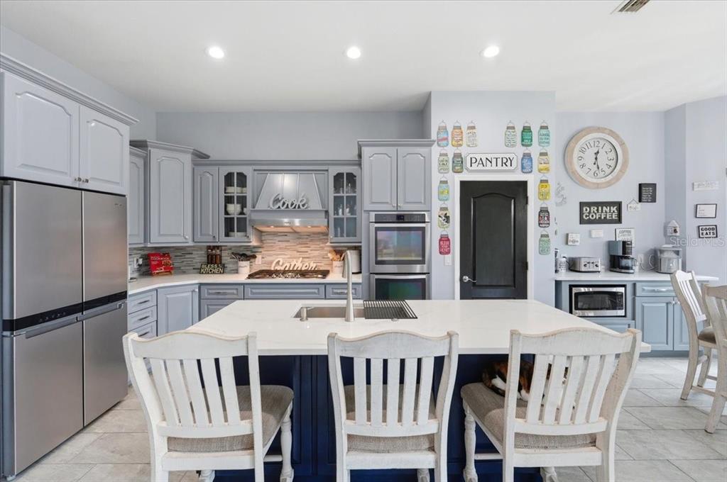 3943 West Campbell Road Lakeland, FL 33810 - Photo 36 of 95 a kitchen with stainless steel appliances granite countertop a dining table and chairs