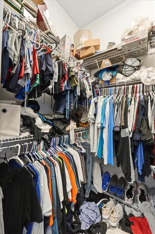 3943 West Campbell Road Lakeland, FL 33810 - Photo 54 of 95 a view of walk in closet with clothes and shoes