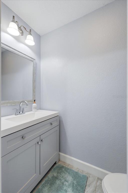 3943 West Campbell Road Lakeland, FL 33810 - Photo 59 of 95 a bathroom with a sink vanity and a toilet