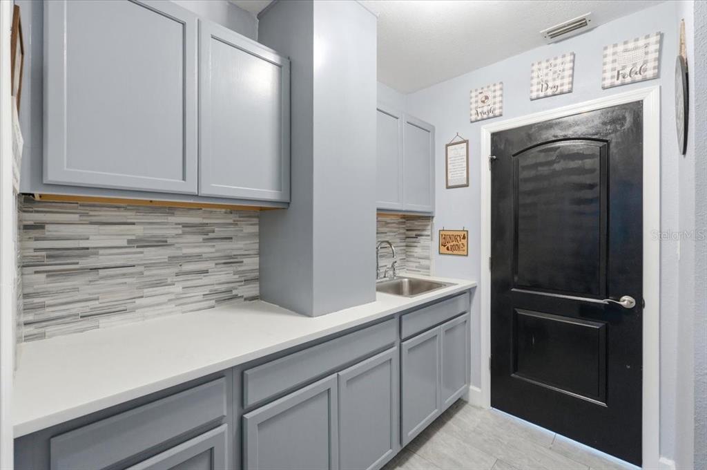 3943 West Campbell Road Lakeland, FL 33810 - Photo 61 of 95 a kitchen with a refrigerator and cabinets