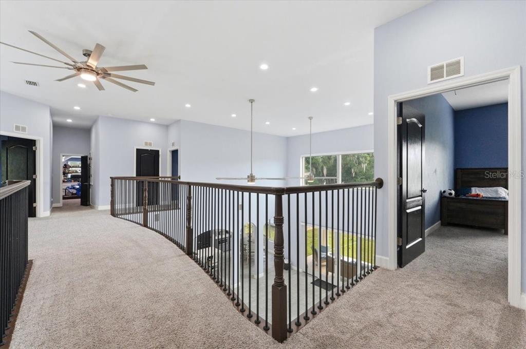3943 West Campbell Road Lakeland, FL 33810 - Photo 64 of 95 a view of a hallway with a flat screen tv