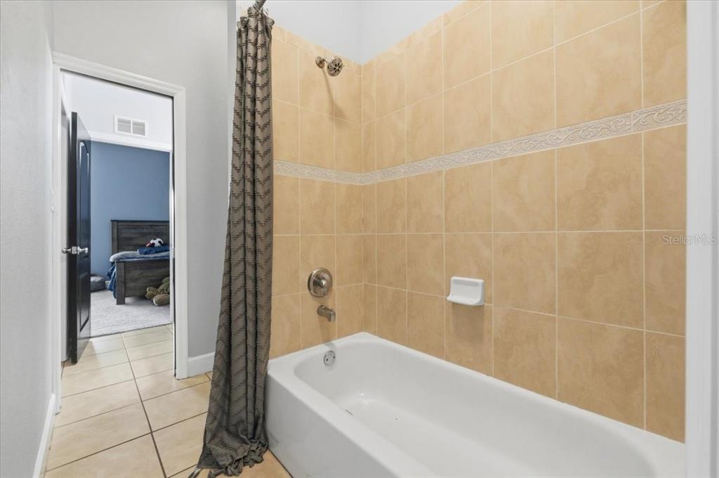 3943 West Campbell Road Lakeland, FL 33810 - Photo 73 of 95 a bathroom with a bathtub and a shower
