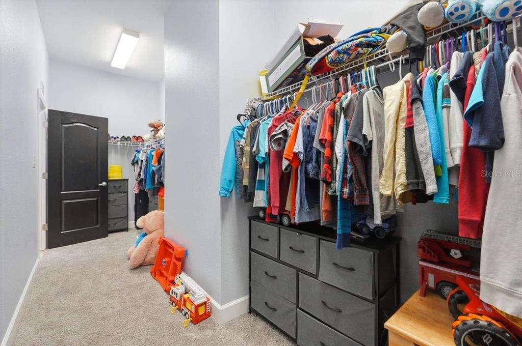 3943 West Campbell Road Lakeland, FL 33810 - Photo 74 of 95 a view of walk in closet with clothes and shoes