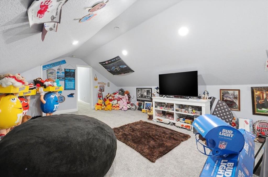 3943 West Campbell Road Lakeland, FL 33810 - Photo 84 of 95 a living room with furniture and a flat screen tv