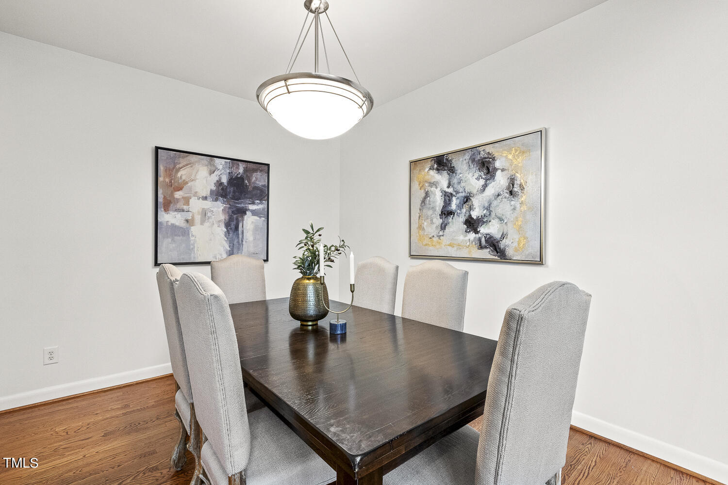 805 The Village Circle Raleigh, NC 27615 - Photo 11 of 42 a view of a dining room with furniture and wooden floor