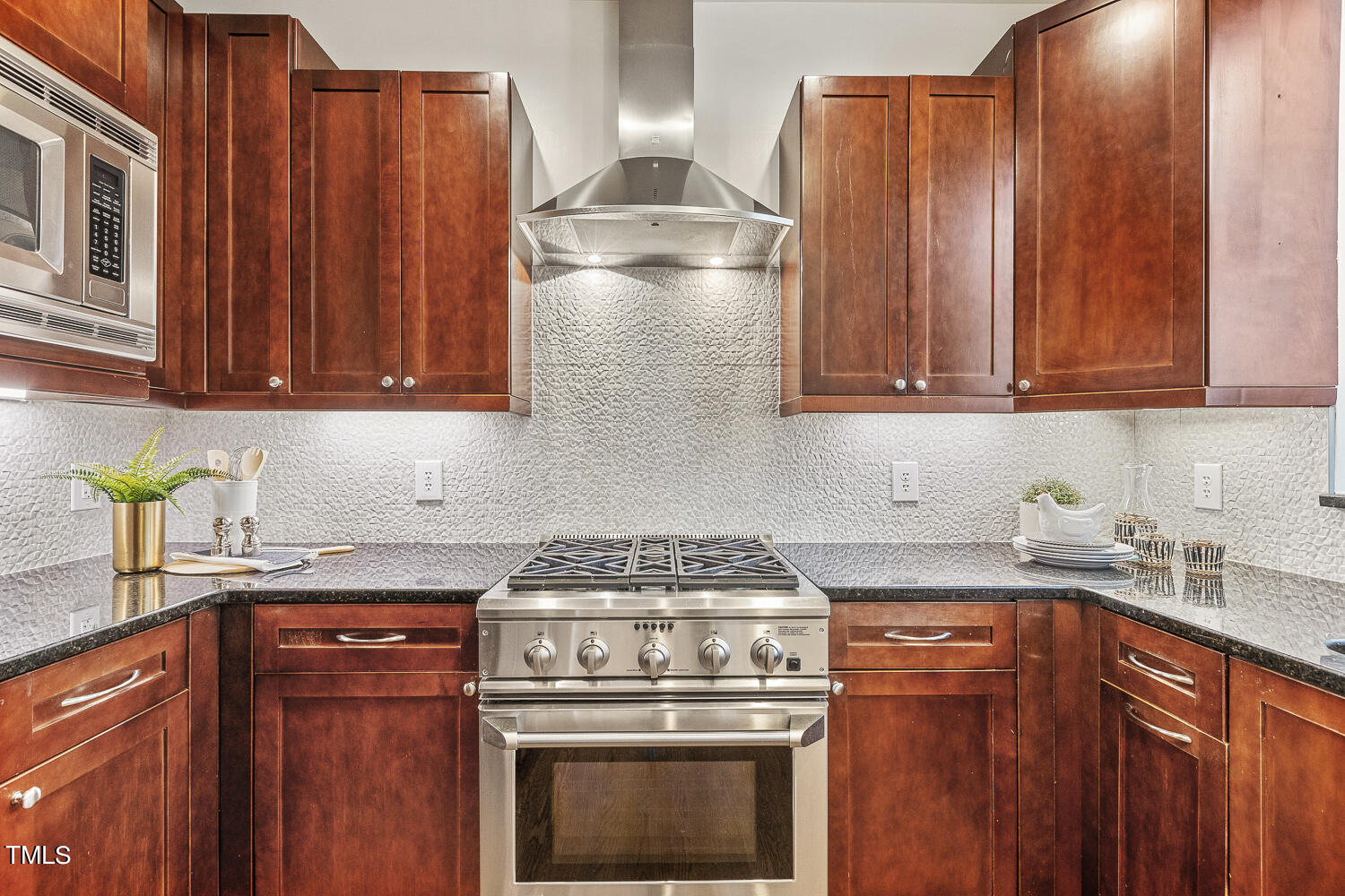 805 The Village Circle Raleigh, NC 27615 - Photo 12 of 42 a kitchen with granite countertop a stove top oven cabinetry a sink and dishwasher
