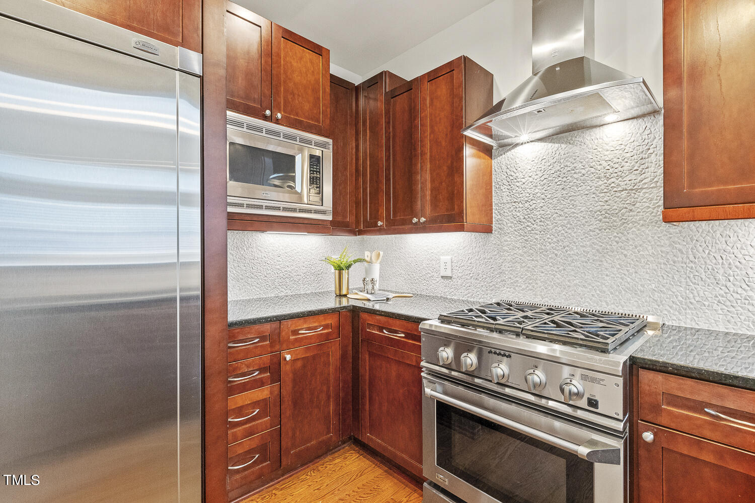 805 The Village Circle Raleigh, NC 27615 - Photo 13 of 42 a kitchen with stainless steel appliances granite countertop a stove and a microwave