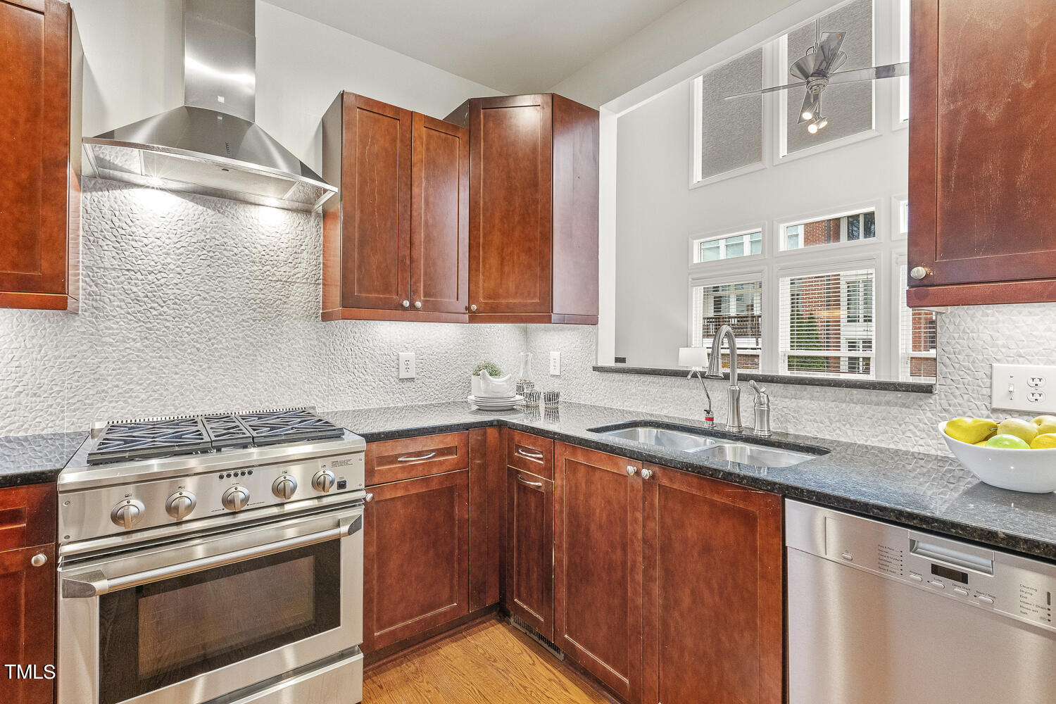 805 The Village Circle Raleigh, NC 27615 - Photo 16 of 42 a kitchen with granite countertop a sink stainless steel appliances and cabinets