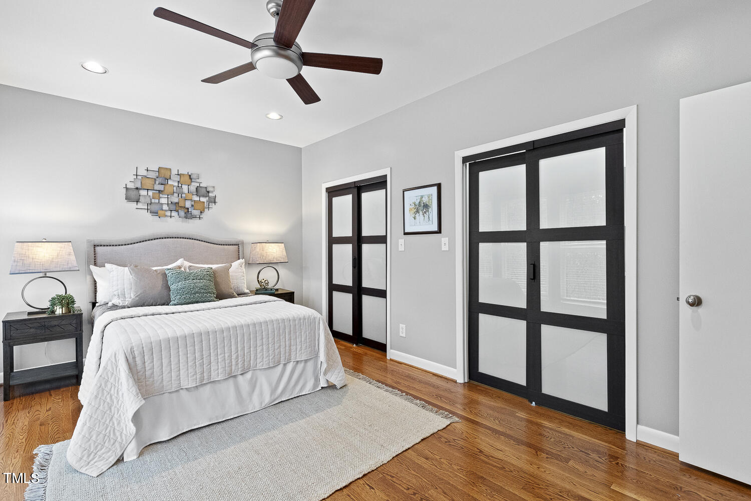 805 The Village Circle Raleigh, NC 27615 - Photo 19 of 42 a bedroom with a large bed chandelier and a window