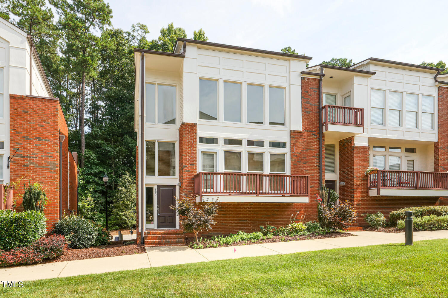805 The Village Circle Raleigh, NC 27615 - Photo 2 of 42 front view of a building with a yard