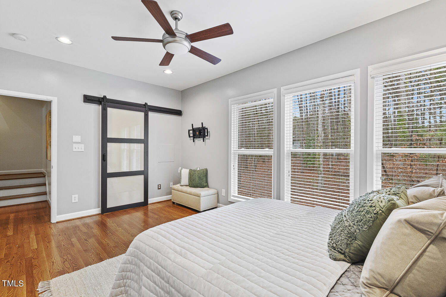805 The Village Circle Raleigh, NC 27615 - Photo 21 of 42 a bedroom with a large bed and a large window