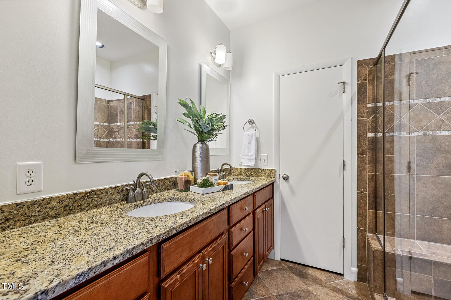 805 The Village Circle Raleigh, NC 27615 - Photo 23 of 42 a bathroom with a granite countertop sink and a mirror