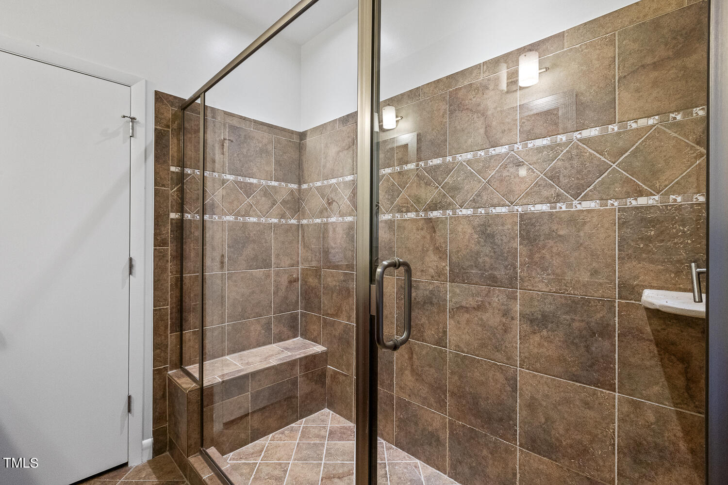 805 The Village Circle Raleigh, NC 27615 - Photo 24 of 42 a bathroom with a shower and a sink
